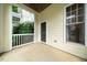 Covered back porch overlooking greenery and the building exterior at 1301 Durlain Dr # 103, Raleigh, NC 27614
