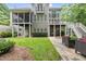 Spacious backyard featuring a covered porch, deck, patio, and lush greenery, offering ample space for outdoor living at 1308 Woodgate Manor Ct, Raleigh, NC 27614