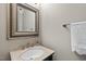 Bathroom vanity features a marble countertop, brushed nickel faucet, and decorative mirror at 1308 Woodgate Manor Ct, Raleigh, NC 27614