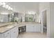 Bright bathroom with double sinks, granite counters, vanity area, and a large framed mirror at 1308 Woodgate Manor Ct, Raleigh, NC 27614