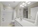 Bright bathroom with a white vanity, large mirror, and a shower-tub combination at 1308 Woodgate Manor Ct, Raleigh, NC 27614