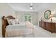 Bedroom with a bed, dresser, and view of the outdoors through French doors at 1308 Woodgate Manor Ct, Raleigh, NC 27614