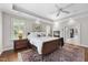 Bedroom with fireplace, neutral walls, and white trim, with an ensuite walk-in closet at 1308 Woodgate Manor Ct, Raleigh, NC 27614