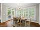 Dining room with chandelier, table, and chairs with views of the outdoor porch area at 1308 Woodgate Manor Ct, Raleigh, NC 27614