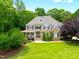 Charming two-story home with stone and shingle facade, lush landscaping and inviting front porch at 1308 Woodgate Manor Ct, Raleigh, NC 27614