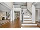 Elegant foyer with hardwood floors, staircase, and ample natural light at 1308 Woodgate Manor Ct, Raleigh, NC 27614