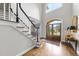Grand foyer features a staircase, hardwood floors, and a view of the front door at 1308 Woodgate Manor Ct, Raleigh, NC 27614