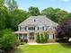 Stunning two-story home with manicured lawn and charming stone and siding exterior at 1308 Woodgate Manor Ct, Raleigh, NC 27614