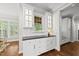 Convenient kitchen with display cabinets, granite countertops, and serving area at 1308 Woodgate Manor Ct, Raleigh, NC 27614