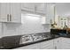 Well-equipped kitchen features stainless steel gas range and subway tile backsplash at 1308 Woodgate Manor Ct, Raleigh, NC 27614