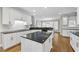 Spacious kitchen featuring white cabinets, black countertops, and stainless steel appliances at 1308 Woodgate Manor Ct, Raleigh, NC 27614