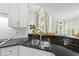 The kitchen features stainless steel appliances, and a beautiful sink with views of the backyard at 1308 Woodgate Manor Ct, Raleigh, NC 27614