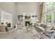Bright living room with built-in shelves, fireplace, and large windows at 1308 Woodgate Manor Ct, Raleigh, NC 27614
