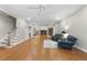 Spacious living room featuring hardwood floors, a fireplace, and comfortable seating at 1308 Woodgate Manor Ct, Raleigh, NC 27614