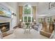 Spacious living room with fireplace, large windows, and elegant decor at 1308 Woodgate Manor Ct, Raleigh, NC 27614