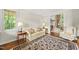 Comfortable living room featuring a decorative rug, neutral-toned furniture and plenty of natural light at 1308 Woodgate Manor Ct, Raleigh, NC 27614