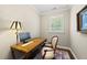 Bright office with a decorative wood desk and chair and a beautiful decorative rug at 1308 Woodgate Manor Ct, Raleigh, NC 27614