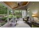 Inviting outdoor porch features dining and sitting areas with tranquil views of the surrounding landscape at 1308 Woodgate Manor Ct, Raleigh, NC 27614