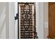 Ornate iron gate revealing a traditional wine cellar with wooden storage racks at 1308 Woodgate Manor Ct, Raleigh, NC 27614