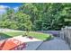 Landscaped backyard featuring a well-maintained lawn and stone-edged patio area at 133 Marino Pl, Clayton, NC 27527