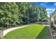 Spacious, grassy backyard enclosed by a wooden fence and lined with mature trees at 133 Marino Pl, Clayton, NC 27527