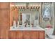 Bathroom features a double vanity, wood cabinets, and stylish light fixtures at 133 Marino Pl, Clayton, NC 27527