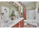 Light-filled bathroom featuring a double vanity and a shower-tub combo at 133 Marino Pl, Clayton, NC 27527