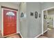 Inviting entryway featuring a decorative red door and stylish interior decor at 133 Marino Pl, Clayton, NC 27527
