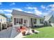 Charming home features a cozy porch with rocking chairs and a beautifully manicured lawn at 133 Marino Pl, Clayton, NC 27527