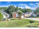 Well-kept brick home with an attached garage, green lawn, and mature trees creating a serene setting at 133 Marino Pl, Clayton, NC 27527