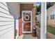 Charming front door adorned with a colorful wreath and decorative welcome sign at 133 Marino Pl, Clayton, NC 27527