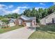 Attractive brick home with a red front door, a paved driveway, and a well-manicured lawn at 133 Marino Pl, Clayton, NC 27527