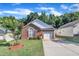 Inviting brick home with well-maintained lawn and a paved driveway leading to the garage at 133 Marino Pl, Clayton, NC 27527
