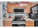 Modern kitchen with sleek appliances, cooktop, and unique overhead microwave at 133 Marino Pl, Clayton, NC 27527