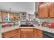 The kitchen features a large sink, wood cabinetry, and vintage Coca-cola themed decor at 133 Marino Pl, Clayton, NC 27527