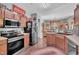 Well-lit kitchen boasts stainless appliances, wooden cabinetry, and Coca-Cola themed decor at 133 Marino Pl, Clayton, NC 27527