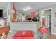 Open kitchen view with vintage Coca-cola decor, breakfast bar and sleek appliances at 133 Marino Pl, Clayton, NC 27527