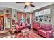 Warm living room featuring a comfortable red sofa, decorative accents, and ample natural light at 133 Marino Pl, Clayton, NC 27527