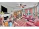 Cozy living room with a fireplace, ceiling fan, and an open view to the dining area at 133 Marino Pl, Clayton, NC 27527