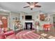 Living room showcasing hardwood floors, fireplace, and vintage Coca-cola decor at 133 Marino Pl, Clayton, NC 27527