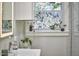 Upgraded bathroom featuring a designer window, modern fixtures, and glass-enclosed shower at 1408 Ida St, Durham, NC 27705