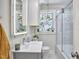 Bright bathroom featuring a glass shower, vanity, and plant accents at 1408 Ida St, Durham, NC 27705