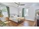 Sun-filled bedroom with hardwood floors, neutral decor, and a comfortable bed at 1408 Ida St, Durham, NC 27705
