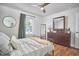 Relaxing bedroom featuring a ceiling fan, natural light, and a stylish mirror at 1408 Ida St, Durham, NC 27705