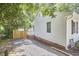 This exterior view showcases the home's features with wood fence and yard at 1408 Ida St, Durham, NC 27705