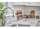 Close-up of kitchen featuring white countertops and modern stainless steel faucet at 1408 Ida St, Durham, NC 27705