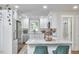 Well-lit kitchen with white cabinets, granite counters, and stainless steel appliances at 1408 Ida St, Durham, NC 27705