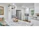 Charming kitchen with integrated washer/dryer, stainless steel fridge, and bright cabinets at 1408 Ida St, Durham, NC 27705