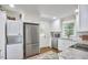 Contemporary kitchen with stainless appliances, white cabinets, and integrated washer/dryer at 1408 Ida St, Durham, NC 27705
