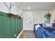 Inviting living room with hardwood floors, stylish blue sofa, green accent wall and natural light at 1408 Ida St, Durham, NC 27705
